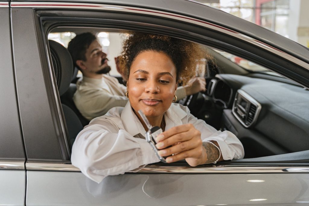woman inside car while holding car keys