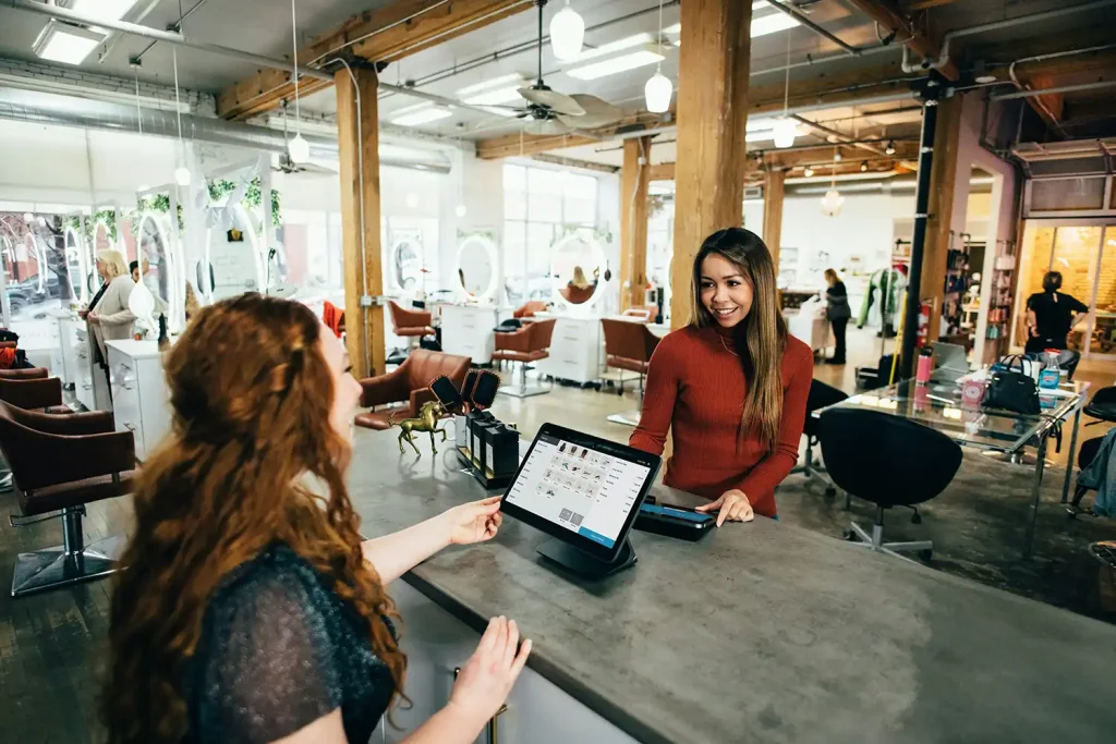 two women talking in a small business
