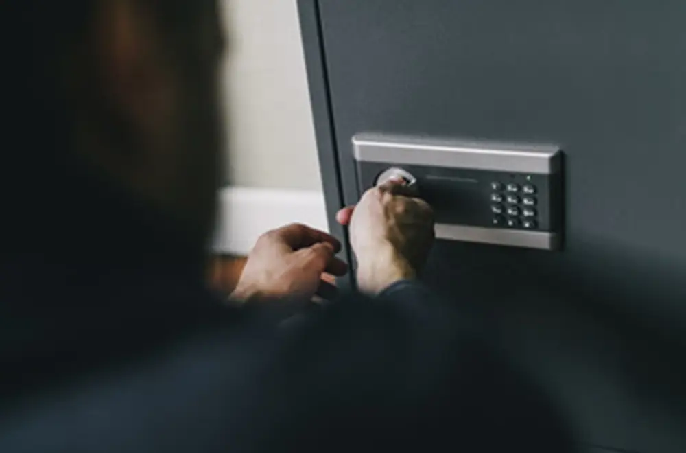 person opening a mechanical safe