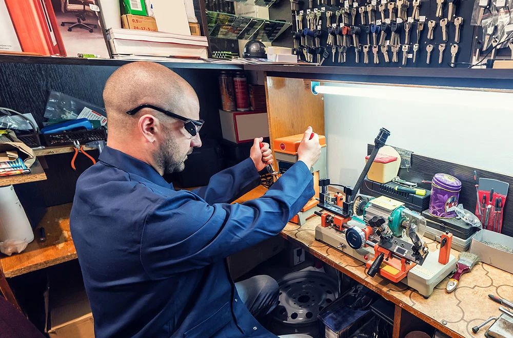 worker cutting a key